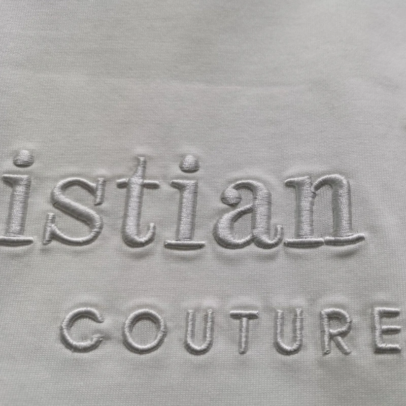 Raised text embroidery 3D embossed lettering Textured stitch design Embroidered lettering effect