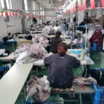 Fashion designers discussing fabrics and trims for a new clothing collection.