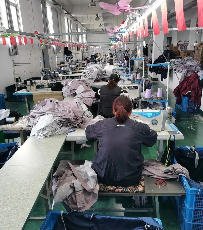Fashion designers discussing fabrics and trims for a new clothing collection.