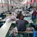 Fashion designers discussing fabrics and trims for a new clothing collection.