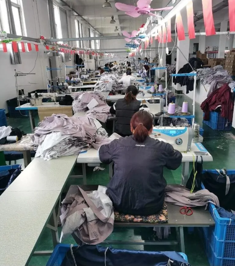 Fashion designers discussing fabrics and trims for a new clothing collection.